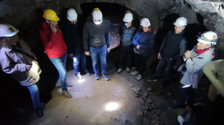 Group tour exploring the underground quarry galleries of the Temple of Claudius in Rome.