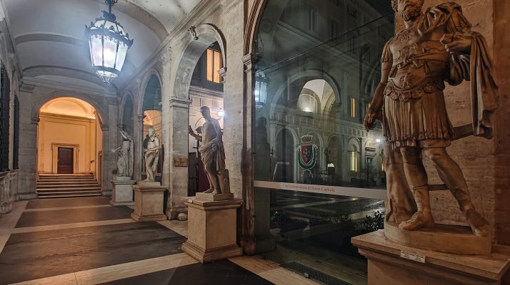 Corridor of Palazzo Valentini with statues and arches