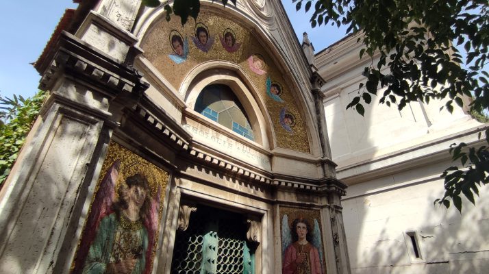 The neoclassical architecture of the Monumental Cemetery of Verano in Rome with detailed artwork.