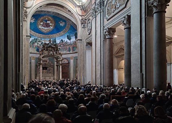 Interior of Santa Croce in Gerusalemme with attendees and artwork.