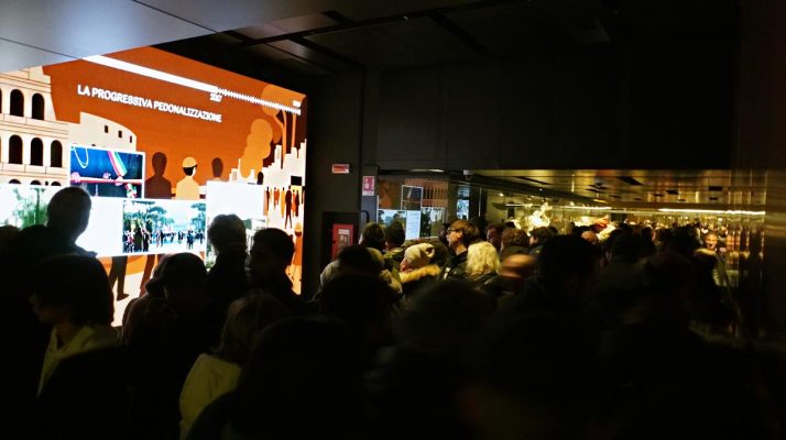 Exhibition area in a dead-end corridor in front of the ticket gates of the Colosseo – Fori Imperiali metro station, with visitors stopping