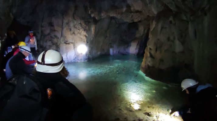 Visitors exploring the underground quarry galleries beneath the Temple of Claudius in Rome